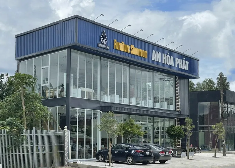 Modern glass-fronted furniture showroom with AN HOA PHAT signage
